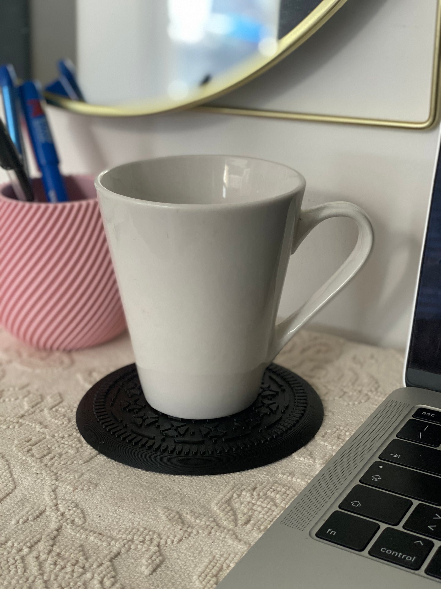 "Unique Realistic Oreo-Shaped Coasters in Light Pink and Black"